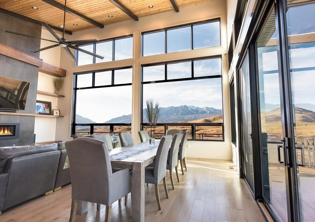 Black Floor-to-Ceiling Windows Elevate Dining and Living Room Design